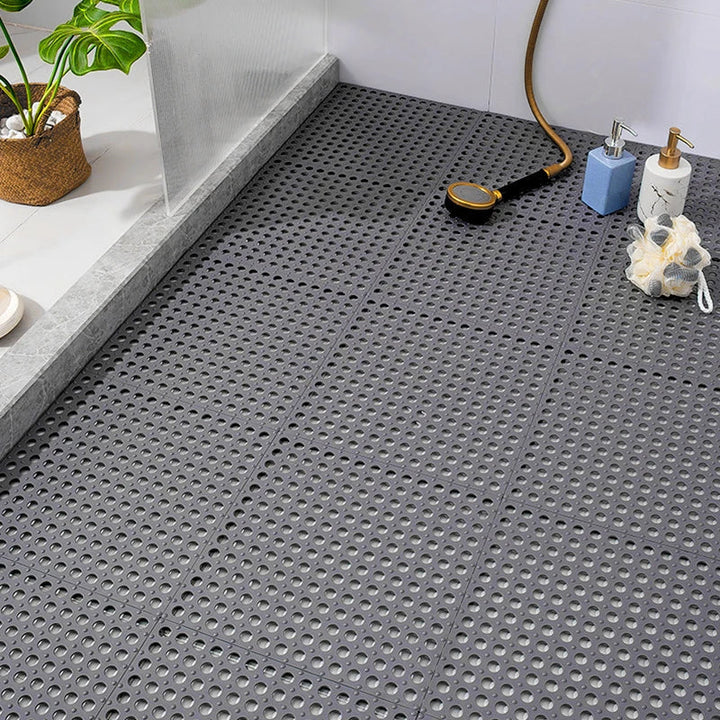 Gray non-slip shower mat set, quick-dry & mold resistant for bathroom safety. Interlocking tiles prevent slips.