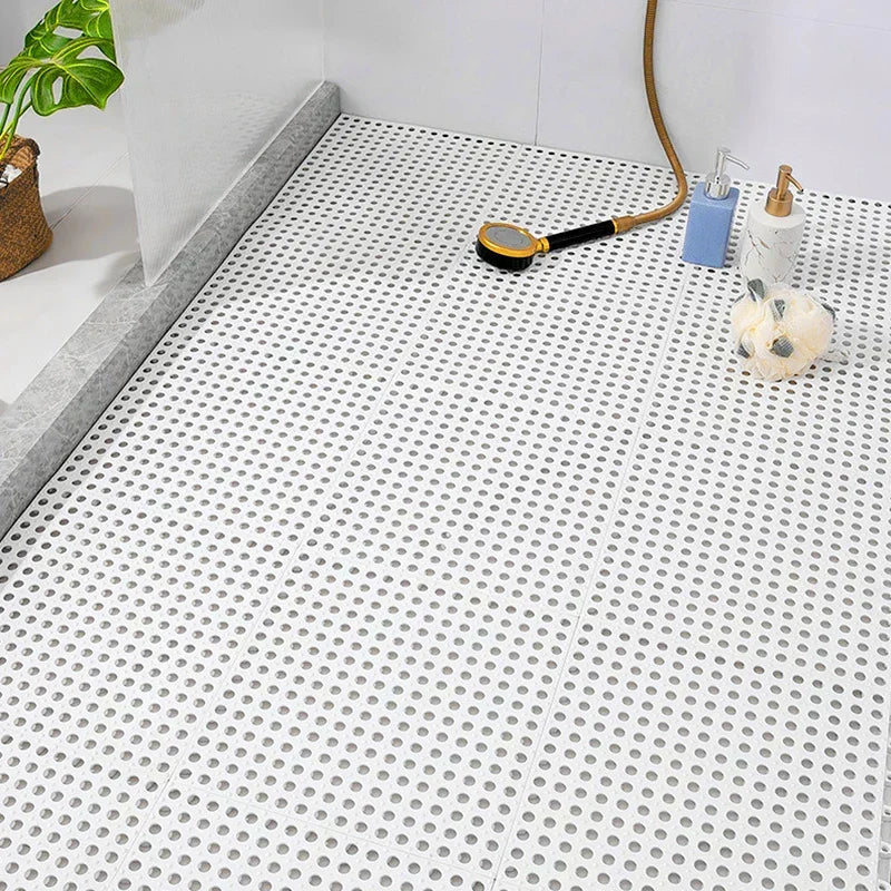 White interlocking shower mat for hygiene. Mold-resistant, quick-dry bath tiles ensure anti-slip bathroom safety.