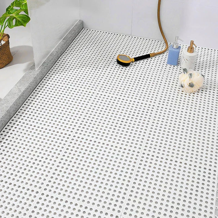 White interlocking shower mat for hygiene. Mold-resistant, quick-dry bath tiles ensure anti-slip bathroom safety.