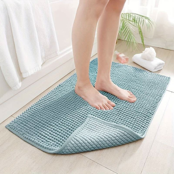 Blue plush chenille bath mat, non-slip & absorbent. Luxurious washable bathroom rug for home decor.