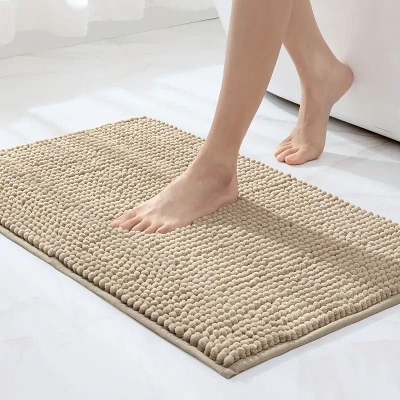 Luxurious beige chenille bath mat, ultra soft and absorbent, featuring non-slip backing. Home decor.