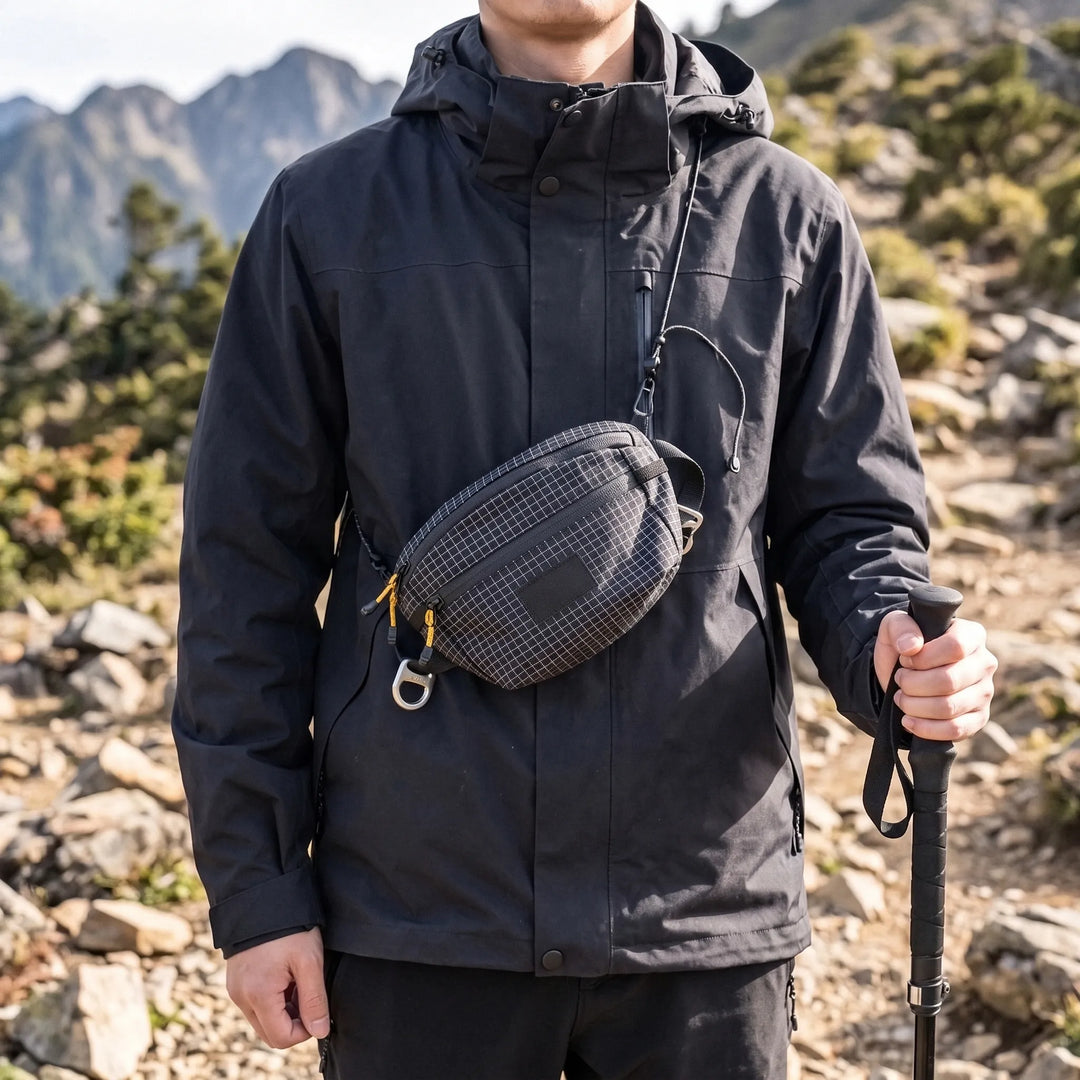 Gray unisex cross chest sling bag with grid pattern, ideal for travel & outdoor activities, offering organized storage.
