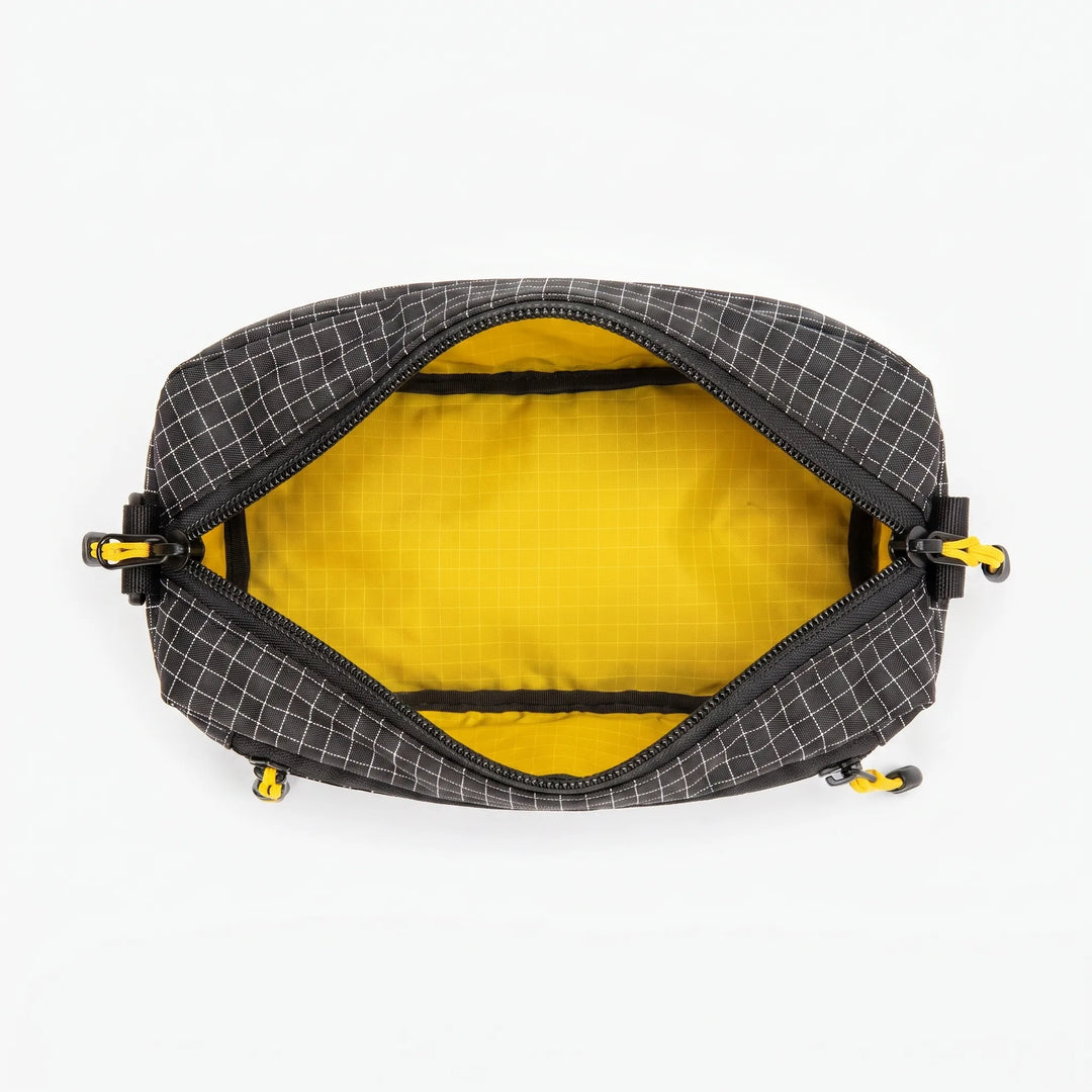 Interior view of gray cross chest bag, showing organized compartments for essentials. A versatile multifunctional sling.