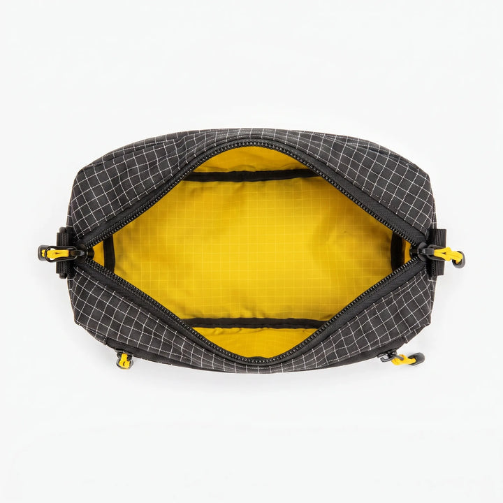 Interior view of gray cross chest bag, showing organized compartments for essentials. A versatile multifunctional sling.
