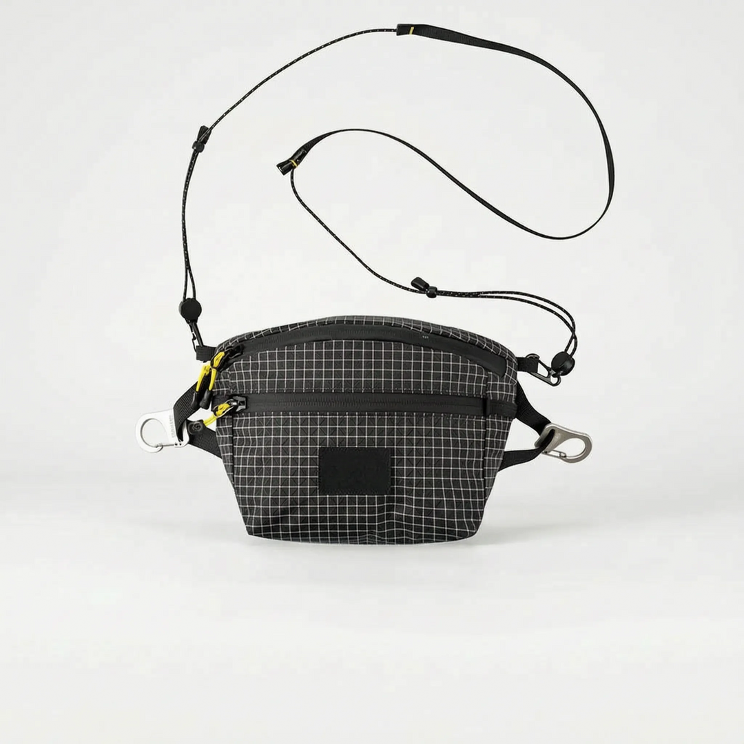 Stylish gray multifunctional crossbody sling bag for men & women, featuring a subtle grid pattern, great for urban travel.