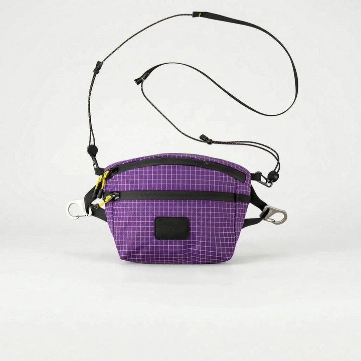 Compact gray cross chest bag with grid pattern, perfect for outdoor adventures & travel, keeping essentials secure & organized.
