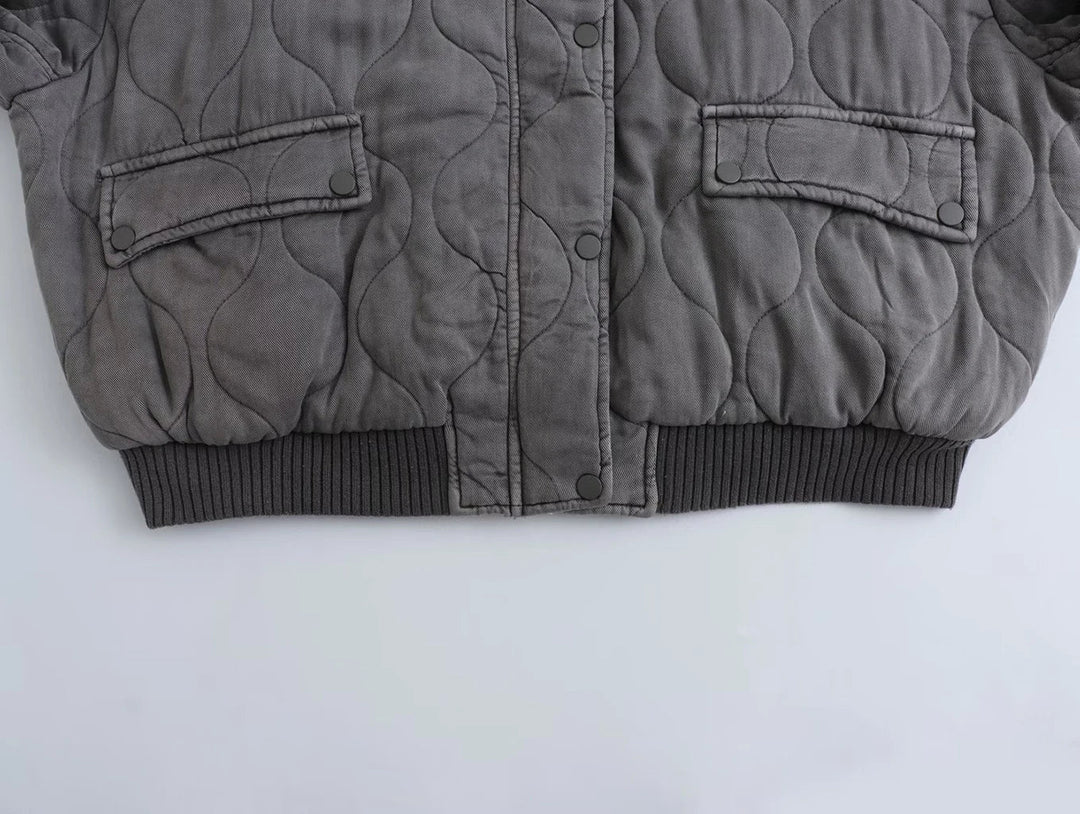 Fashionable women's gray quilted bomber jacket. Essential everyday wear & autumn outerwear for stylish women.
