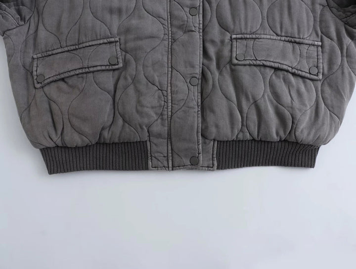 Fashionable women's gray quilted bomber jacket. Essential everyday wear & autumn outerwear for stylish women.