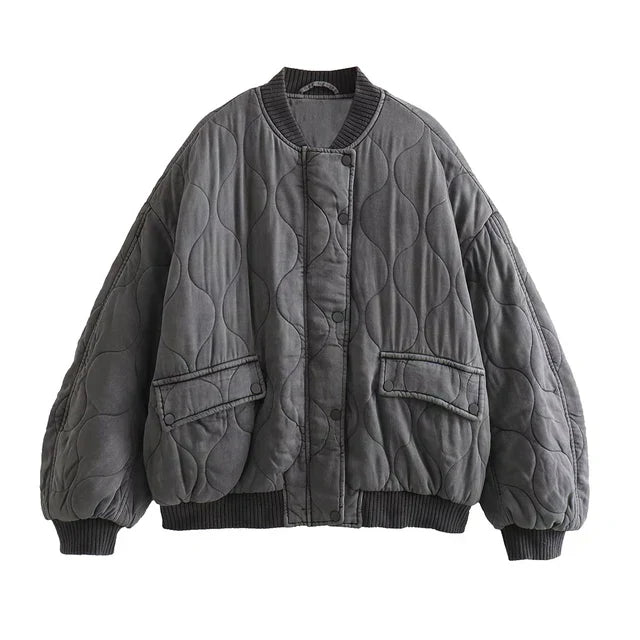 Full shot of a gray women's quilted bomber jacket, showcasing its sleek design & casual winter style.