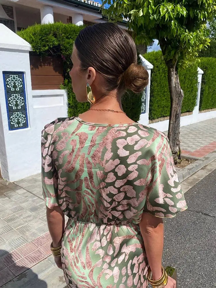 Comfortable women's green abstract print wrap midi dress. Relaxed fit, short sleeve, versatile for summer, party, or vacation.