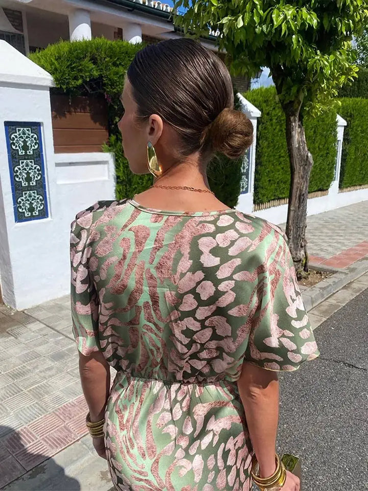 Comfortable women's green abstract print wrap midi dress. Relaxed fit, short sleeve, versatile for summer, party, or vacation.