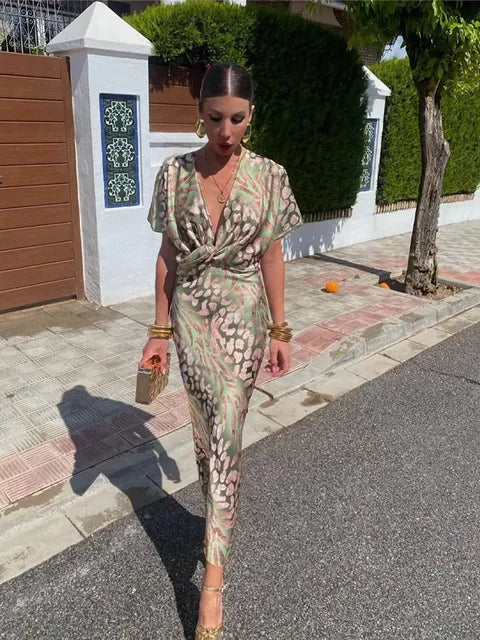 Stylish women's green abstract print wrap midi dress. Relaxed fit, short sleeve design, perfect for elegant summer fashion.