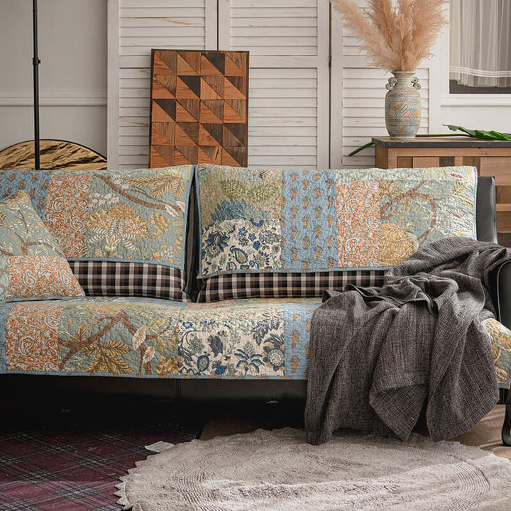 Closeup of green cotton couch cover with delicate floral print, non-slip design, pet friendly.