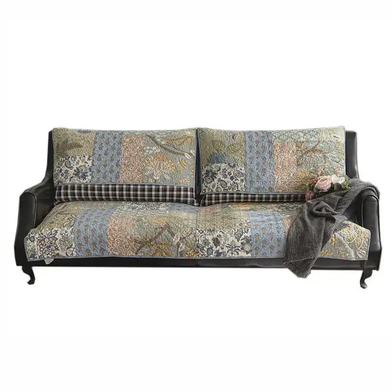 Top-down view of green floral quilted couch cover, showcasing non-slip features and cotton fabric.