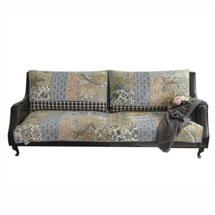 Top-down view of green floral quilted couch cover, showcasing non-slip features and cotton fabric.