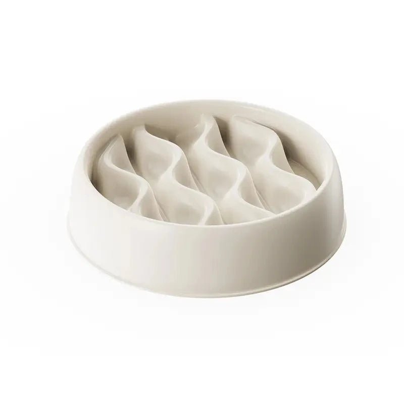 A yellow paw print pet slow feeder bowl on a kitchen floor, durable and easy to clean