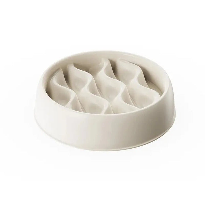 A yellow paw print pet slow feeder bowl on a kitchen floor, durable and easy to clean