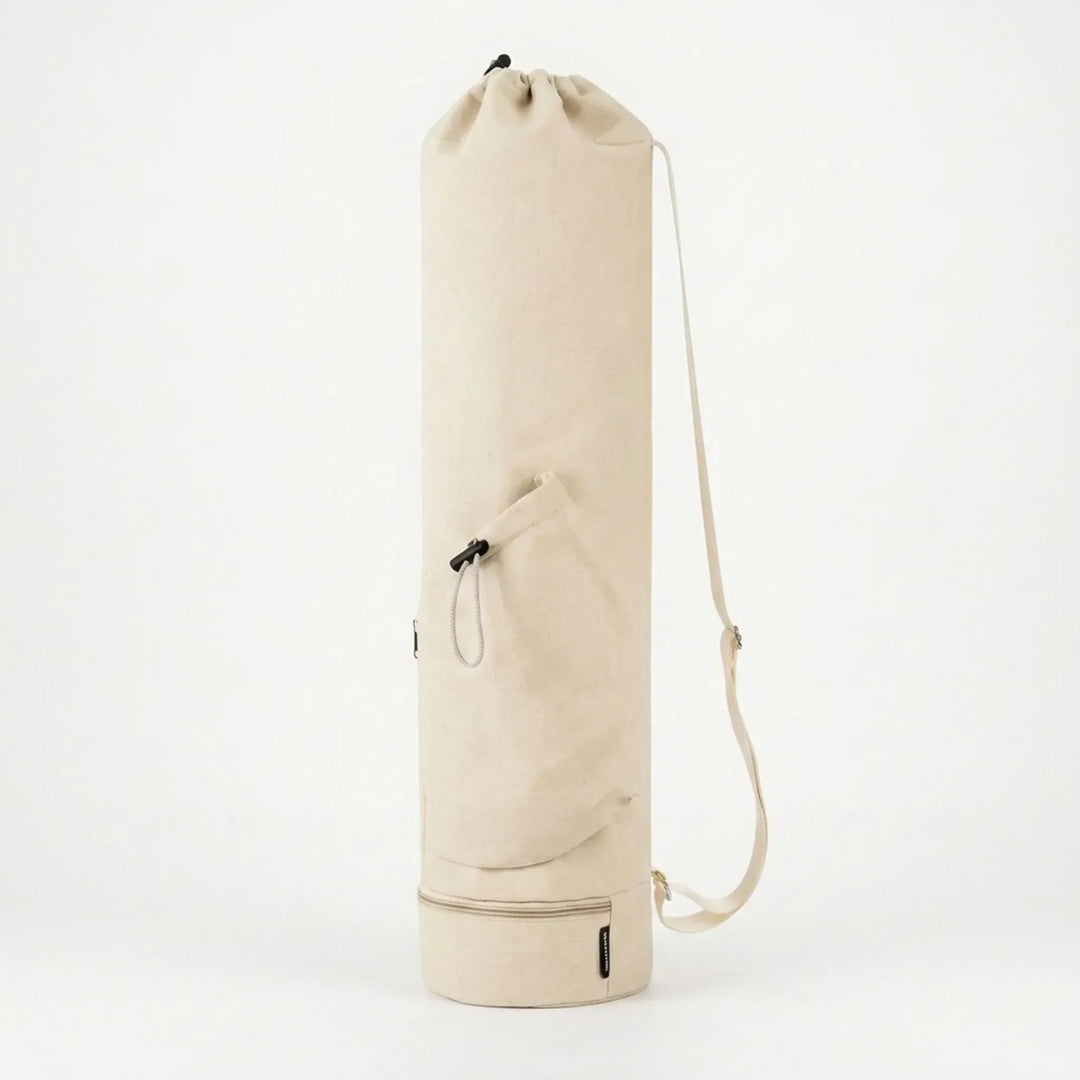 Pink cylindrical yoga mat bag, a stylish activewear accessory for women's pilates and workout gear.