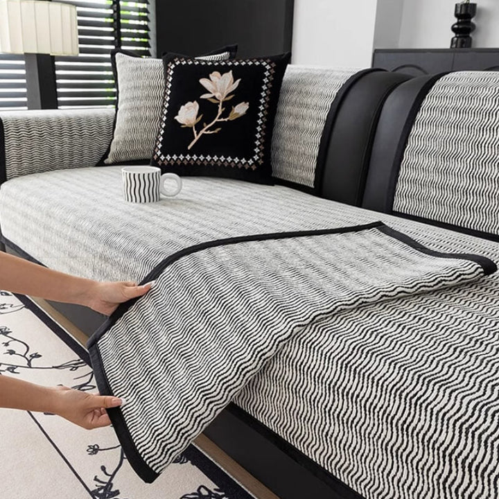Grey chenille non-slip sofa cover protects furniture from pets, scratches & spills, enhancing home decor.