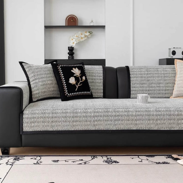 Close-up of the anti-slip backing on a chenille sofa protector, ensuring it stays in place with pets.