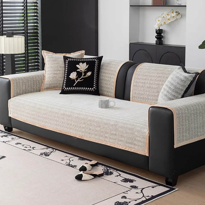Elegant chenille sofa cover protecting a white couch from pet scratches while maintaining decor.
