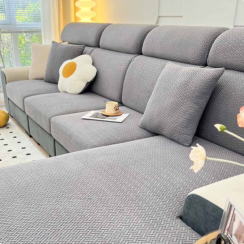 Before and after image showing a worn couch revitalized with a new fleece protector.