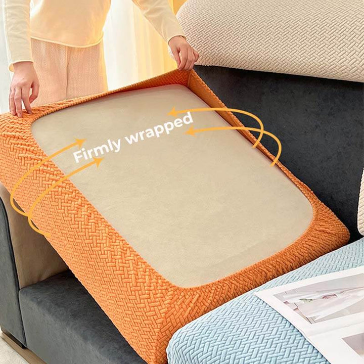 Full view of a living room showcasing a fitted fleece sofa protector on an L-shaped couch.