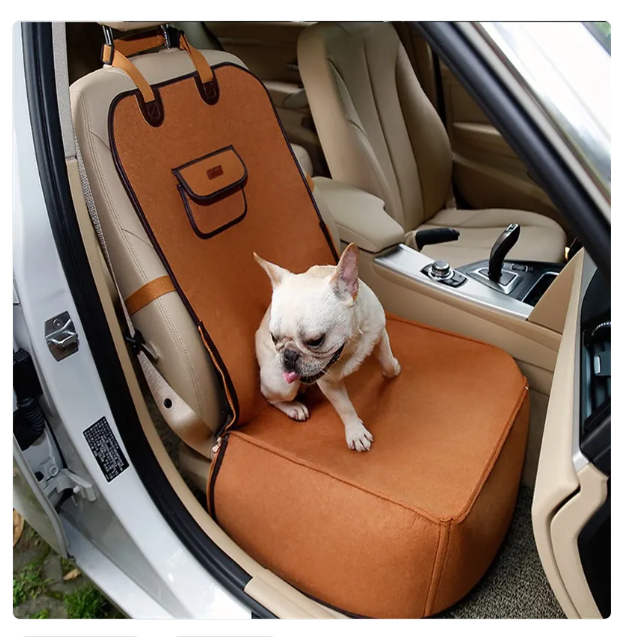 Grey pet car seat with fastening strap for dog travel safety and comfort.