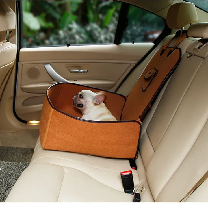 Black unisex pet car seat with secure fastening strap, ideal for dog comfort and safety.