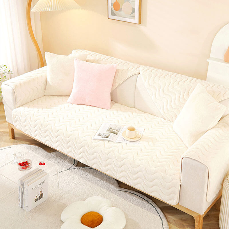Full view of a living room with a grey plush couch cover, adding comfort & style