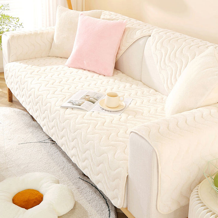 Green plush sectional sofa cover with elegant wave pattern and non-slip design