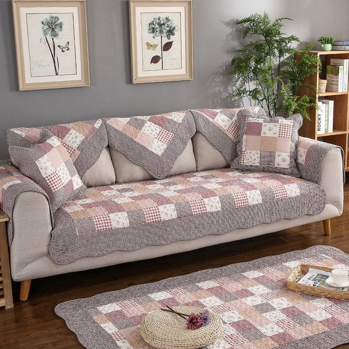 Grey quilted cotton sofa cover, non-slip, protecting a sectional sofa, pet-friendly home decor.