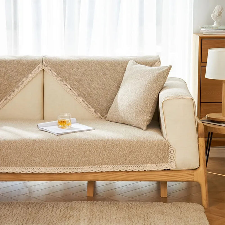 Corner of a sectional sofa covered with a textured cotton linen non-slip protector, snug fit