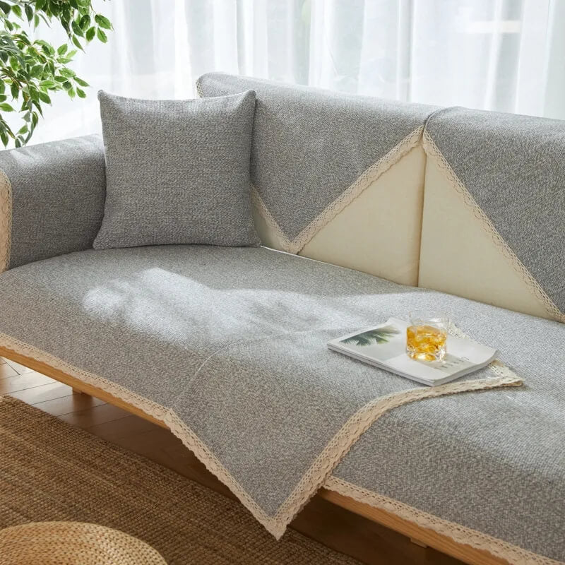 Unisex hand-woven cotton linen sofa protector draped over a sectional, providing full coverage