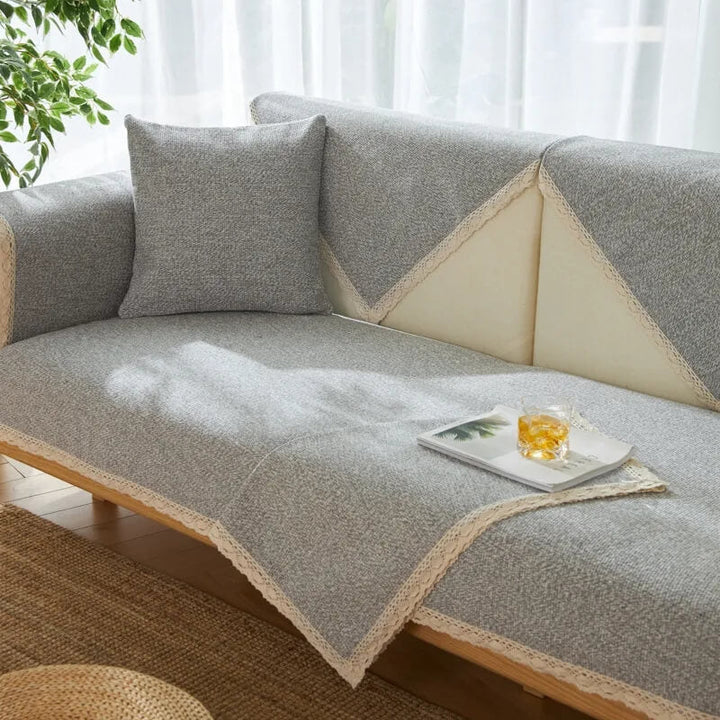 Unisex hand-woven cotton linen sofa protector draped over a sectional, providing full coverage