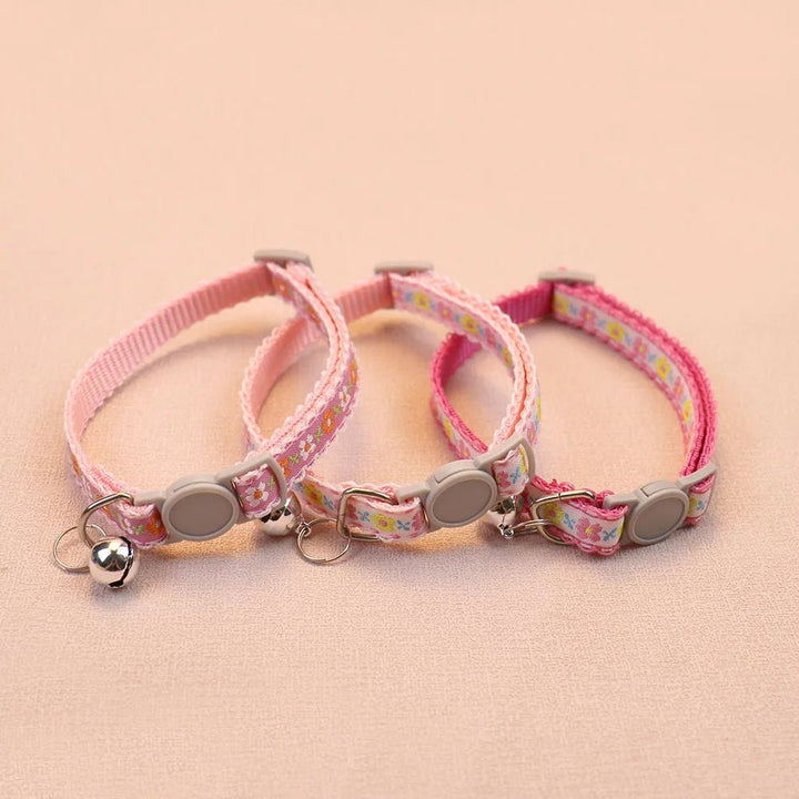 Adjustable handmade floral pet collar for small dogs and cats, showcasing durable fabric & bell.