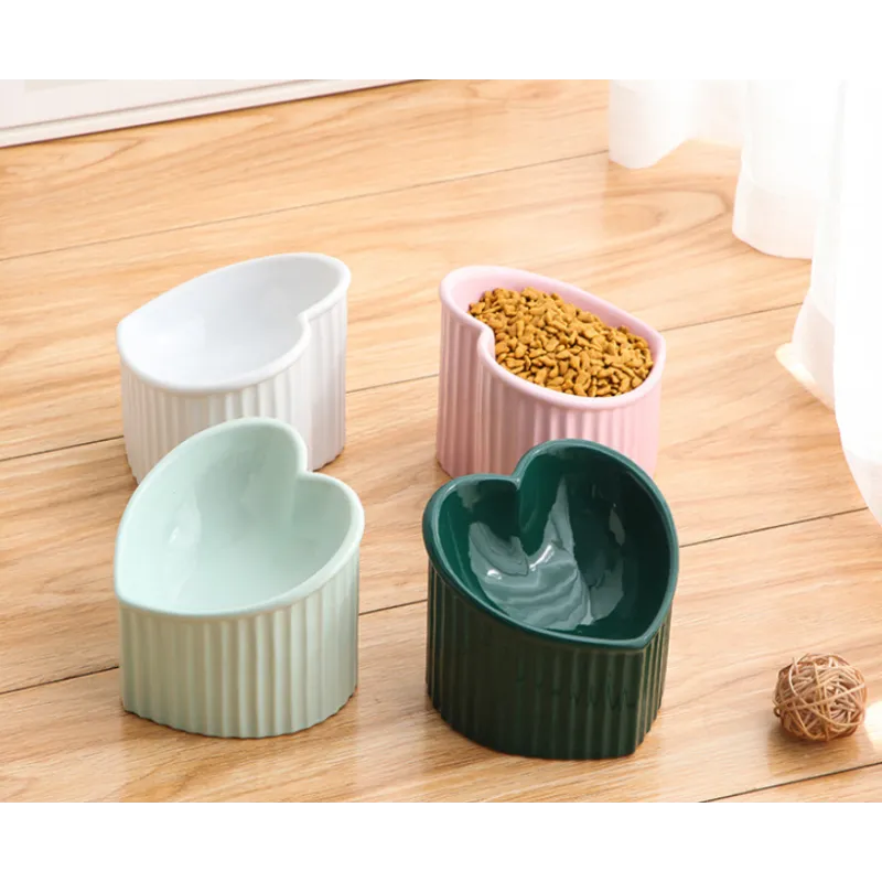 Elegant heart-shaped ceramic dog bowl, white with non-slip bottom, feeder for pet food.