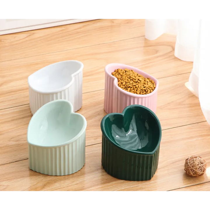 Elegant heart-shaped ceramic dog bowl, white with non-slip bottom, feeder for pet food.