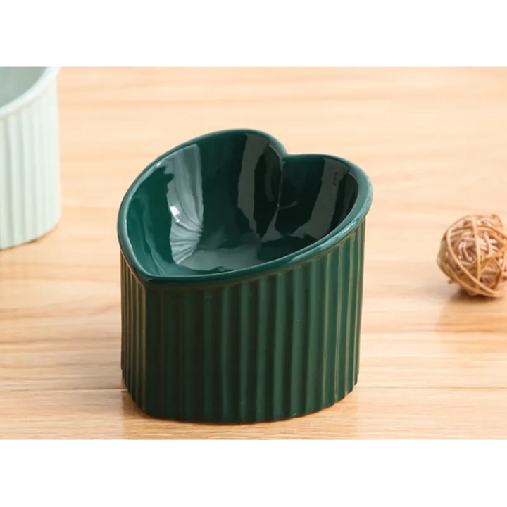 Heart-shaped ceramic pet bowl in a modern kitchen setting, hygienic and decorative pet feeder.