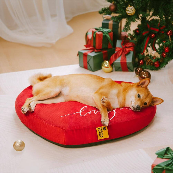 Top view of a vibrant red velvet heart pet bed, ideal for dogs, promoting restful sleep, machine washable