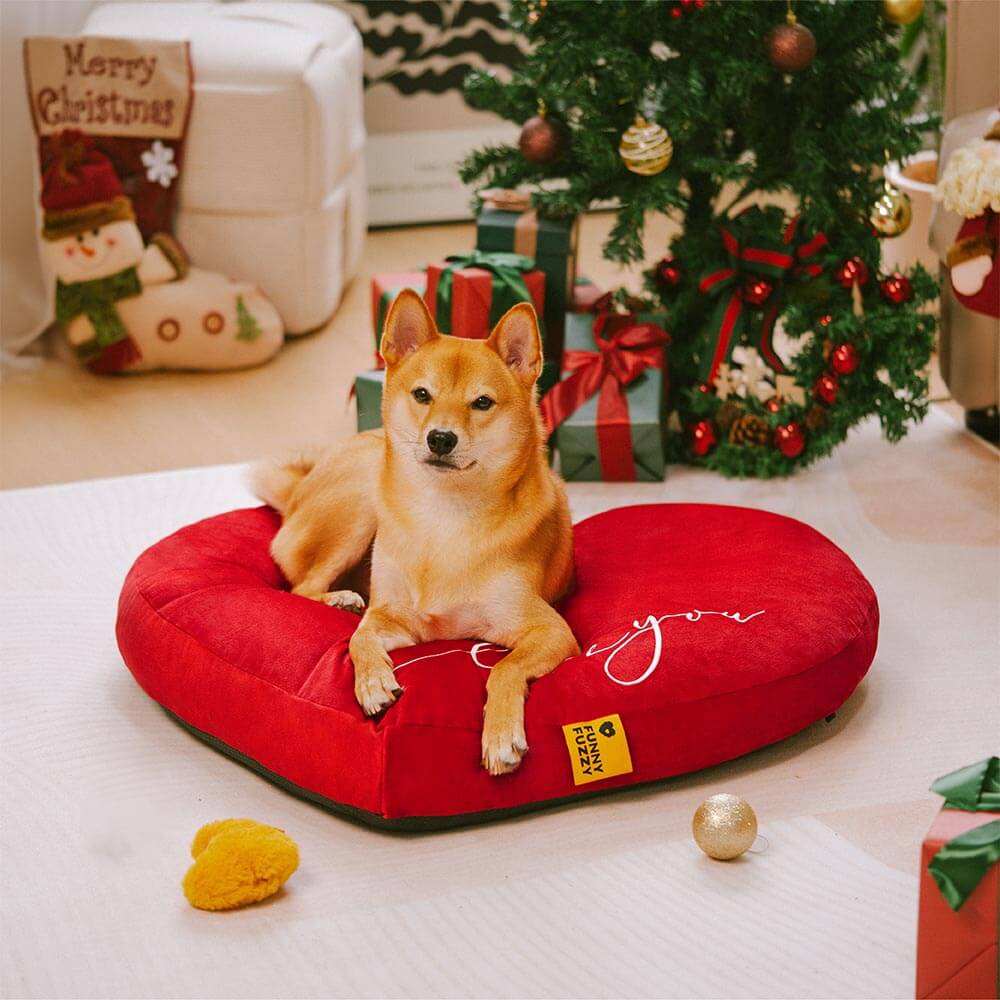 Dog comfortably sleeping in a red heart-shaped velvet pet bed, cozy and warm, anti-slip feature
