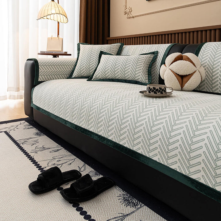 Close-up of herringbone chenille fabric on a sofa protector, showcasing texture and quality.