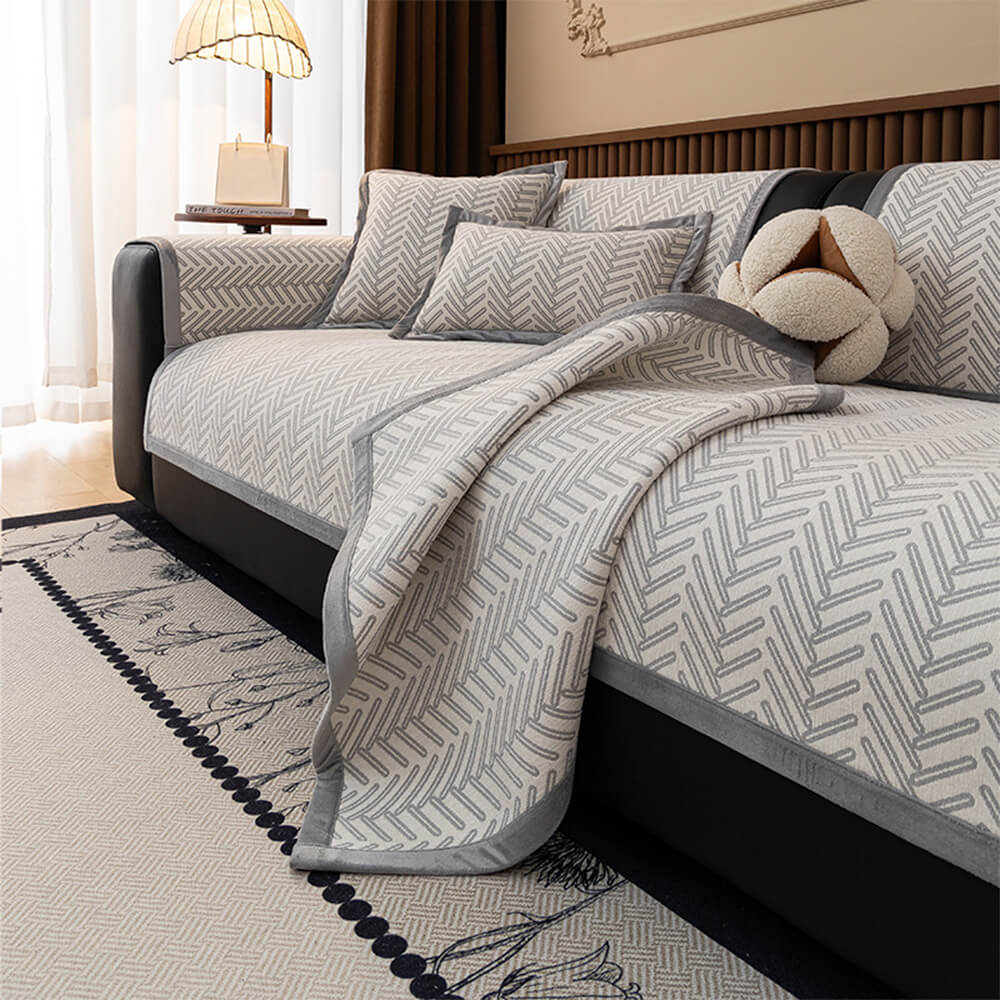 Full view of a living room sofa with a herringbone chenille protector, enhancing home decor.