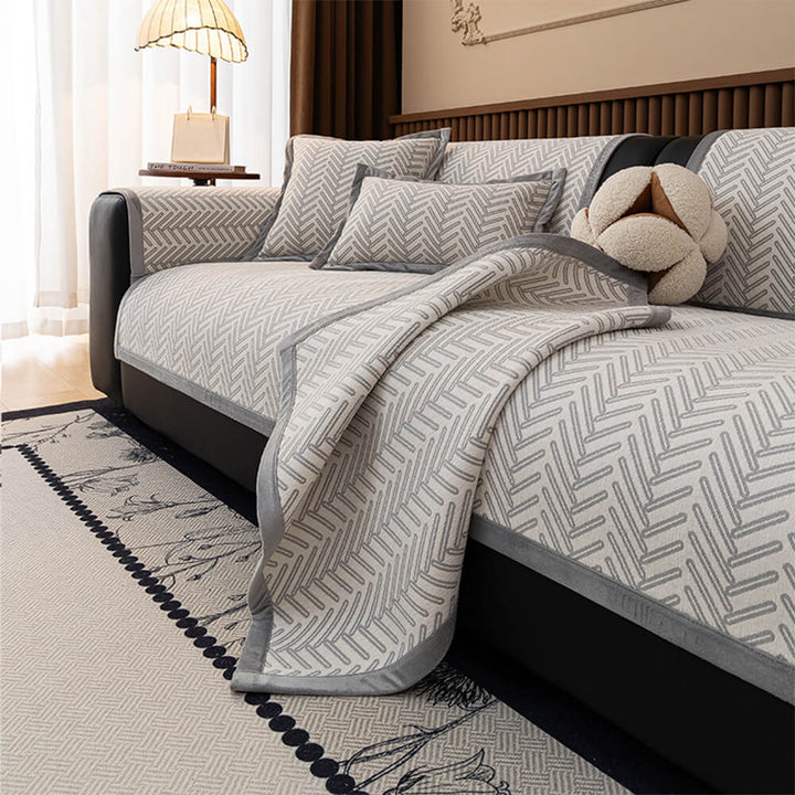 Full view of a living room sofa with a herringbone chenille protector, enhancing home decor.