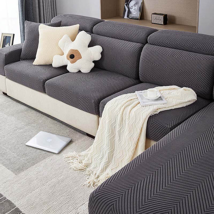Herringbone chenille stretch sofa cover in a living room, protecting furniture from pets