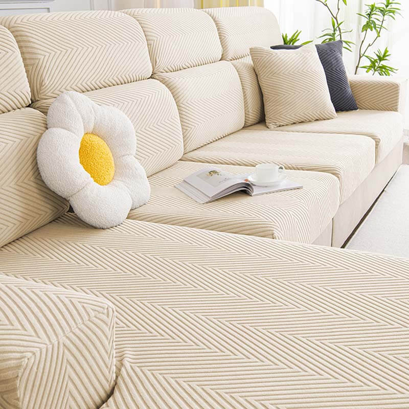 Stretchable pet-friendly herringbone chenille sofa cover in an entryway, protecting furniture