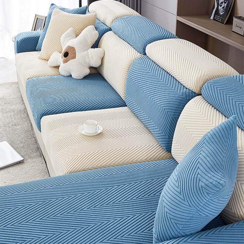 Packaging of a herringbone chenille stretch sofa cover, highlighting its washable features