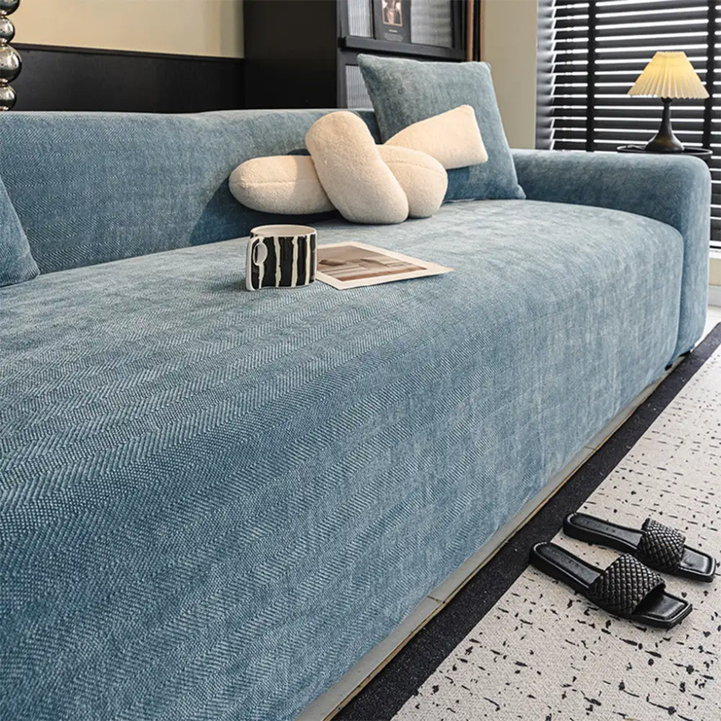 Full coverage stretch couch protector in a herringbone pattern, perfect for updating home decor and safeguarding furniture.