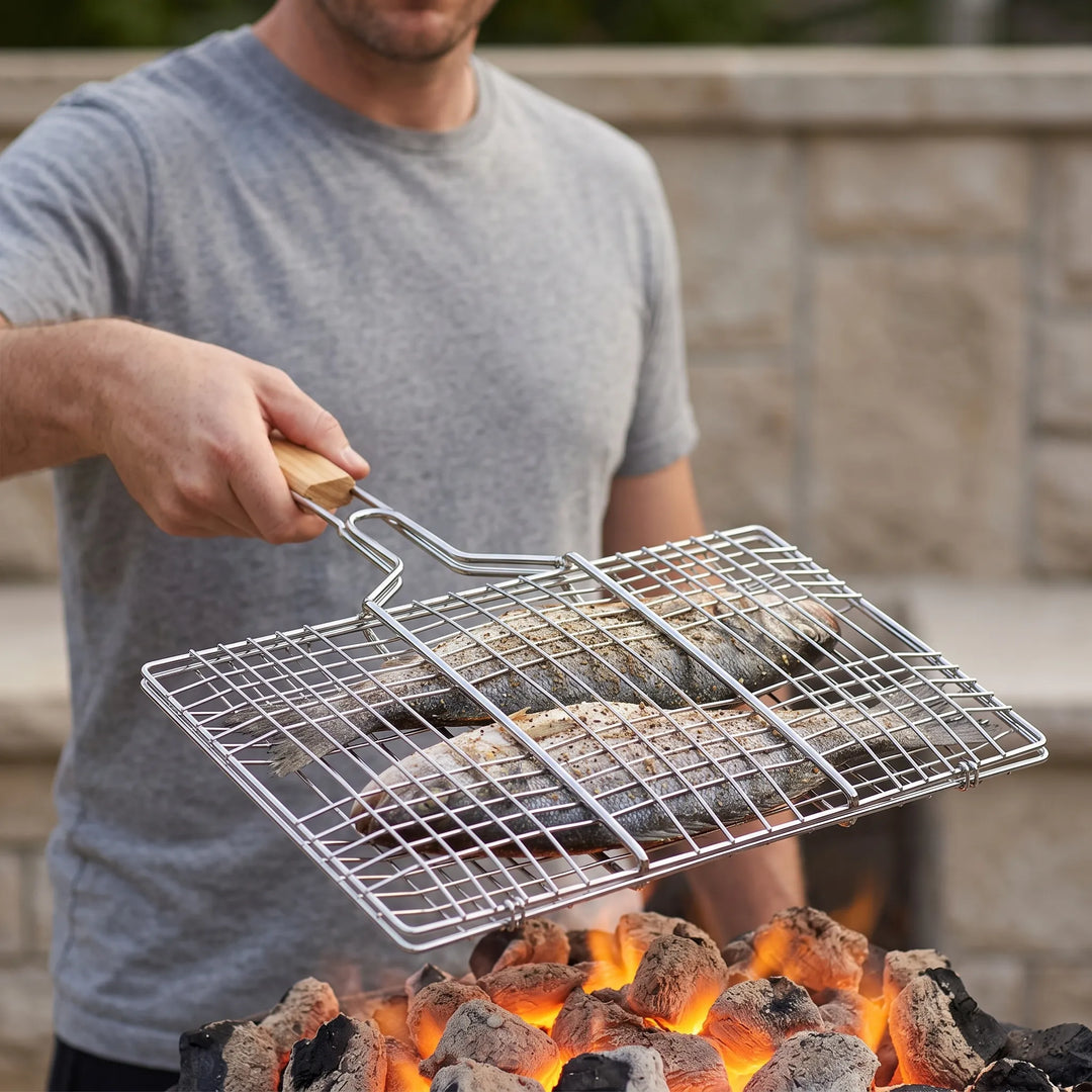 Hinged outdoor grill basket for easy flipping of fish, vegetables, and meat on BBQ or campfire.