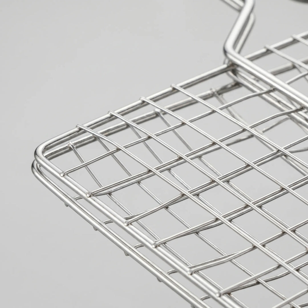 Durable outdoor cooking grill basket for campfire and BBQ. Securely holds food for easy flipping.